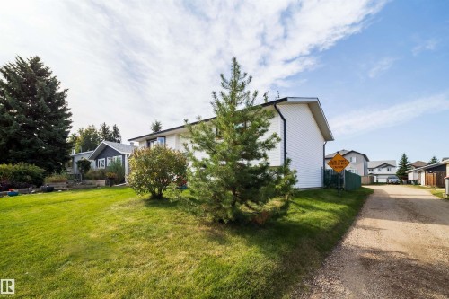 White-sided exterior with black trimmed roofing - 4104 44 Street, Stony Plain, AB 