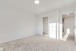 Neutral tone wall paint, plush carpet flooring, recessed ceiling lighting, built-in closet shelving - 
