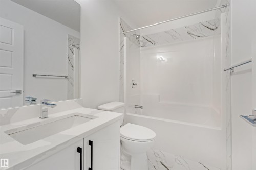 White vanity with integrated rectangular sink, chrome faucet, and black hardware - 1515 211 Street Nw, Edmonton, AB 