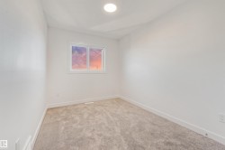 Room featuring light-colored carpeting, white walls, and a single window with white trim - 