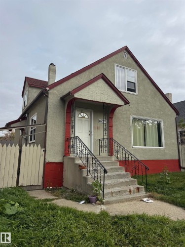 Stucco exterior with a red trim accent and pitched roof - 6729 106 Street Nw, Edmonton, AB 