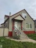 Stucco exterior with a red trim accent and pitched roof - 6729 106 Street Nw, Edmonton, AB 