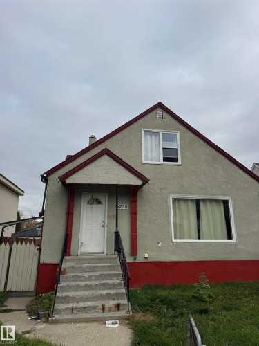 Stucco exterior with contrasting trim, gable roofline, and visible chimney - 6729 106 Street Nw, Edmonton, AB 