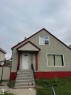 Stucco exterior with contrasting trim, gable roofline, and visible chimney - 6729 106 Street Nw, Edmonton, AB 