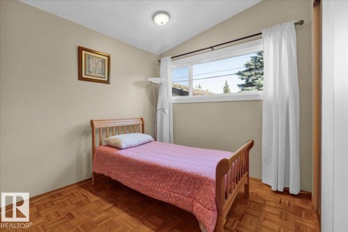 Sloped ceiling, recessed lighting, wood-finish flooring, and a large window - 15012 77 Avenue Nw, Edmonton, AB 
