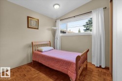 Sloped ceiling, recessed lighting, wood-finish flooring, and a large window - 