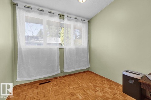 Parquet wood-finish flooring, light green painted walls, and a multi-pane window - 15012 77 Avenue Nw, Edmonton, AB 