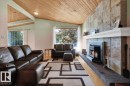Vaulted wood-paneled ceiling with exposed beams, stone-clad fireplace with mantel, and wood-finish flooring - 15012 77 Avenue Nw, Edmonton, AB 