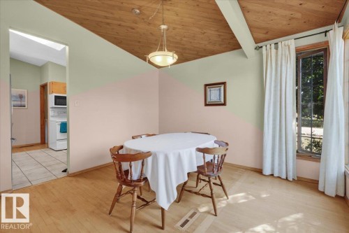 Wood-finish flooring, wood plank ceiling, exposed ceiling beams, recessed lighting, and a large window - 15012 77 Avenue Nw, Edmonton, AB 