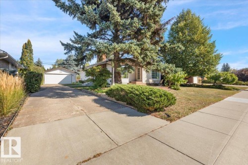 Mature trees and landscaping frame the property - 15012 77 Avenue Nw, Edmonton, AB 