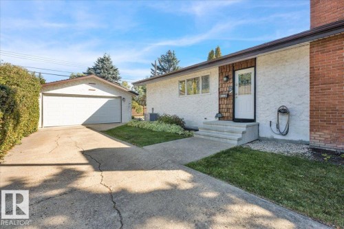 Stucco exterior with brick detailing and wood shingle accents - 15012 77 Avenue Nw, Edmonton, AB 