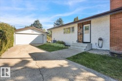 Stucco exterior with brick detailing and wood shingle accents - 