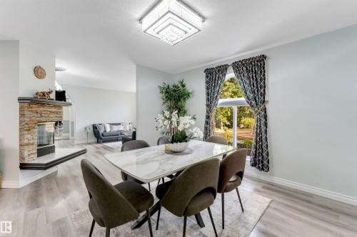 Recessed lighting, wood-finish flooring, and a stacked stone fireplace with a hearth - #37 23020 Township Road 522 Rd, Rural Strathcona County, AB 