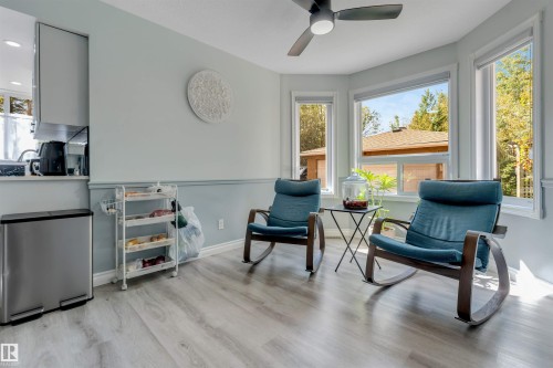 Wood-finish flooring, bay windows, ceiling fan, pass-through opening to kitchen, and upper cabinetry - #37 23020 Township Road 522 Rd, Rural Strathcona County, AB 