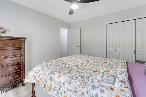 Room featuring wood-finish flooring, a ceiling fan with integrated lighting, and white bi-fold closet doors - #37 23020 Township Road 522 Rd, Rural Strathcona County, AB 