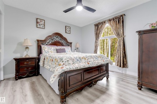 Light-toned wood-finish flooring, a contemporary ceiling fan with integrated lighting, and a window with white framing - #37 23020 Township Road 522 Rd, Rural Strathcona County, AB 