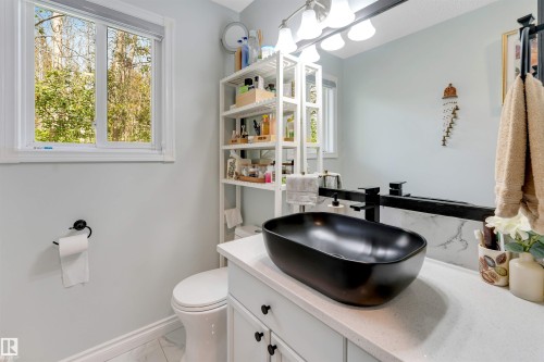 Modern vanity with a black vessel sink, black wall-mounted faucet, and light-toned countertop - #37 23020 Township Road 522 Rd, Rural Strathcona County, AB 