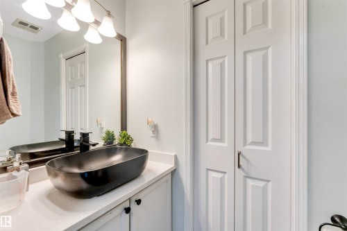 White vanity with quartz countertop, black vessel sink, and wall-mounted black faucet - #37 23020 Township Road 522 Rd, Rural Strathcona County, AB 