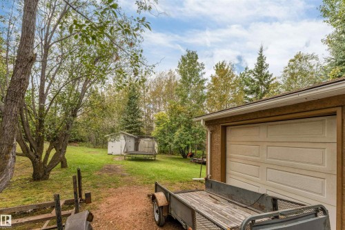 Detached garage with a paneled door, exterior wall with stucco finish, and a gutter system - #37 23020 Township Road 522 Rd, Rural Strathcona County, AB 