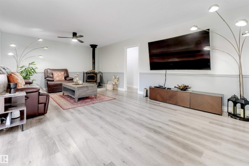 Recessed ceiling lighting, wood-finish flooring, ceiling fan, freestanding wood-burning stove, and wall-mounted television - #37 23020 Township Road 522 Rd, Rural Strathcona County, AB 