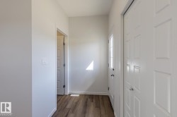 Wood-finish flooring, paneled interior doors, and a door with an integrated window - 