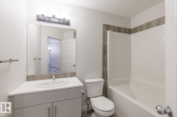 White vanity with an integrated sink and chrome faucet - 