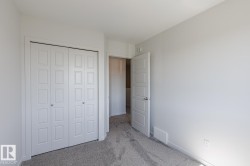 Neutral-toned walls, grey carpet, interior door with paneling, and a bi-fold closet - 
