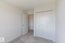 Plush carpet flooring, neutral paint palette, paneled interior door, and bi-fold closet doors - 