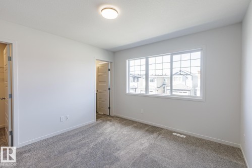 Bright interior with light gray carpeting and white walls - 3611 Triomphe Boulevard, Beaumont, AB 