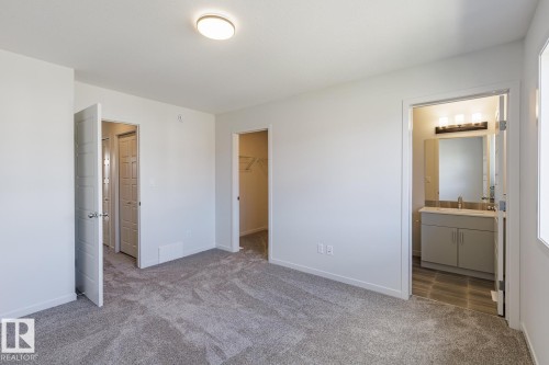 Plush carpeting, recessed lighting, and a walk-in closet - 3611 Triomphe Boulevard, Beaumont, AB 
