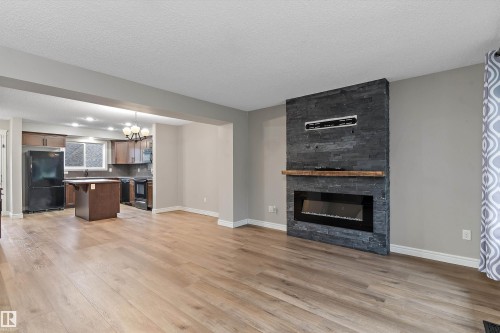2174 Trumpeter Way Nw, Edmonton, AB - Indoor Photo Showing Living Room With Fireplace