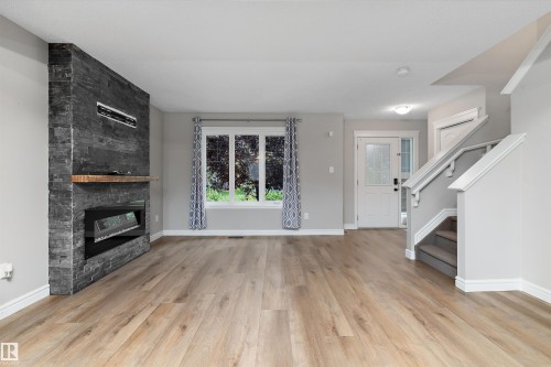 2174 Trumpeter Way Nw, Edmonton, AB - Indoor Photo Showing Living Room With Fireplace