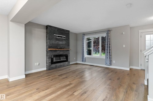 2174 Trumpeter Way Nw, Edmonton, AB - Indoor Photo Showing Living Room With Fireplace