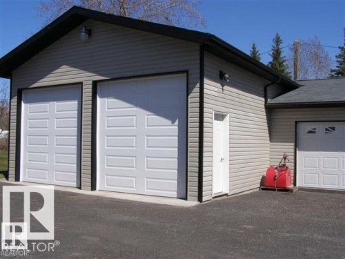 Two-car garage with panel-style doors and a separate entry door - #417 61314 Rr 463, Rural Bonnyville M.D., AB 