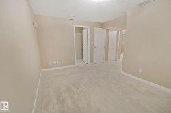 Neutral-toned carpeting, light-colored walls, and multiple interior doors - 