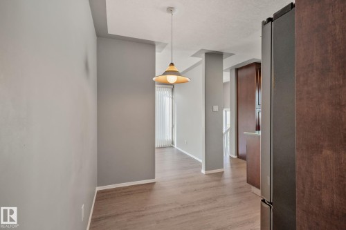 Wood-finish flooring, recessed ceiling, pendant lighting, and vertical window blinds - 14724 73 Street Nw, Edmonton, AB 