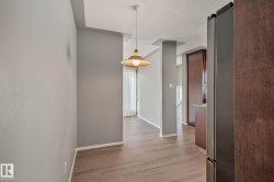 Wood-finish flooring, recessed ceiling, pendant lighting, and vertical window blinds - 