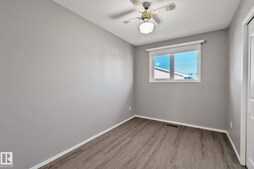 Gray-painted walls with wood-finish flooring - 14724 73 Street Nw, Edmonton, AB 
