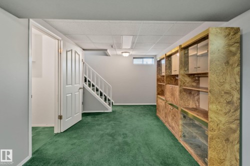 Built-in shelving unit with glass-front cabinets - 14724 73 Street Nw, Edmonton, AB 