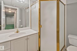 White vanity with integrated sink, brass-finish faucet, and coordinating cabinet hardware - 