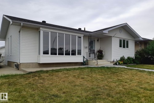 White vinyl siding exterior with an asphalt shingle roof - 14724 73 Street Nw, Edmonton, AB 