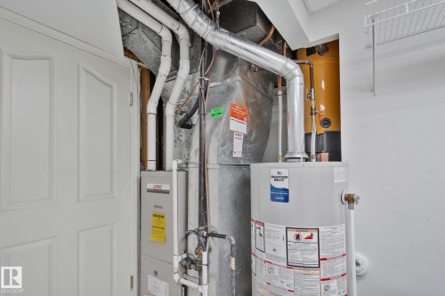 Utility area with a water heater, furnace, and exposed ductwork - 14724 73 Street Nw, Edmonton, AB 