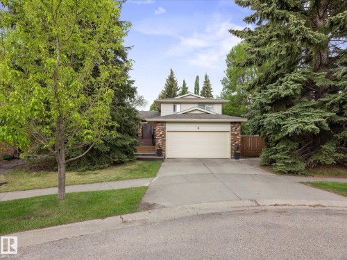 Two-story residence featuring a two-car garage, brick facade accents, and a concrete driveway - 4 Lovatt Place, St. Albert, AB - Outdoor