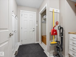 Mudroom entry featuring a six-panel door, built-in coat hooks, and a bench storage nook - 