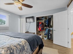 Bedroom featuring wood-finish flooring and light gray wall paint - 