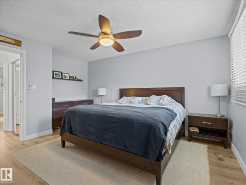 Bedroom featuring wood-finish flooring, light gray walls, and a ceiling fan with integrated lighting - 4 Lovatt Place, St. Albert, AB - Indoor Photo Showing Bedroom
