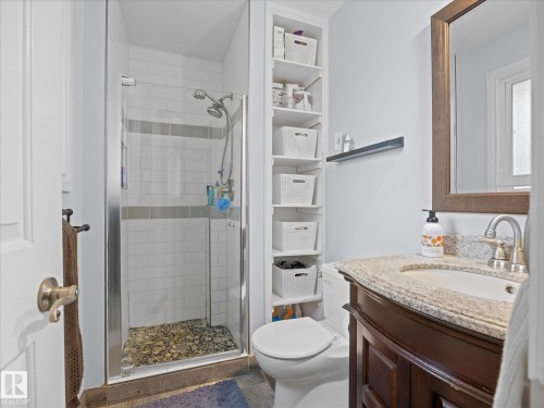 Bathroom featuring a glass-enclosed shower with subway tile surround and pebble flooring - 4 Lovatt Place, St. Albert, AB - Indoor Photo Showing Bathroom
