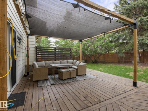Expansive wood deck with a partial overhead shade structure - 4 Lovatt Place, St. Albert, AB - Outdoor With Deck Patio Veranda With Exterior