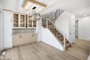 Built-in cabinetry with glass-front uppers and a patterned tile backsplash - 13144 187 Avenue Nw, Edmonton, AB 