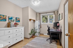 Light wood-finish flooring, neutral wall tones, and a single window with natural light - 